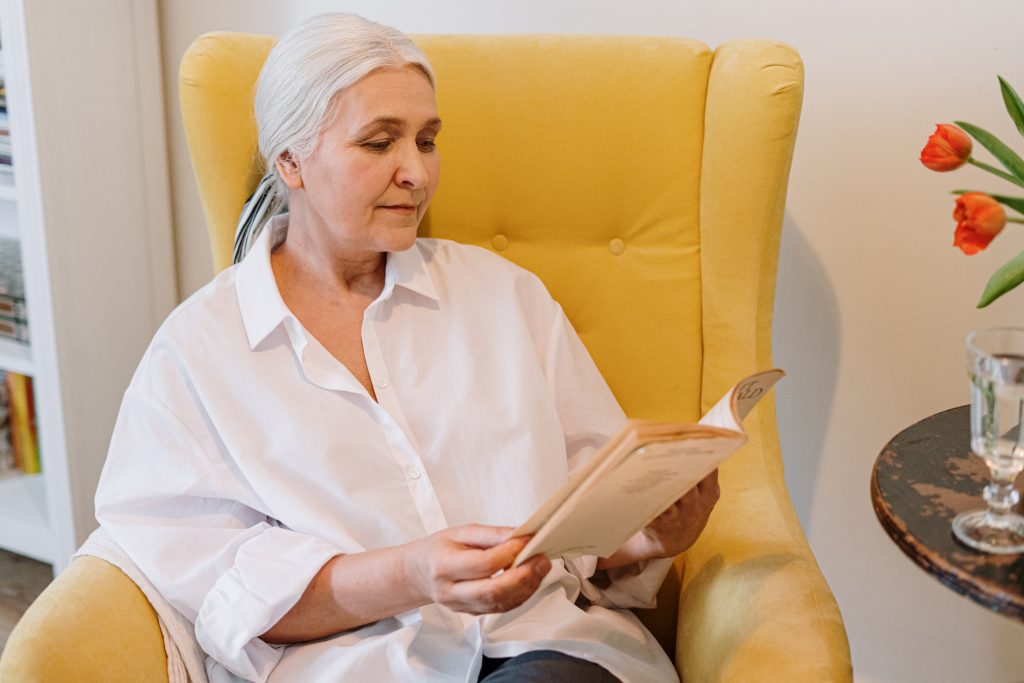 Elderly woman reading a book about grief